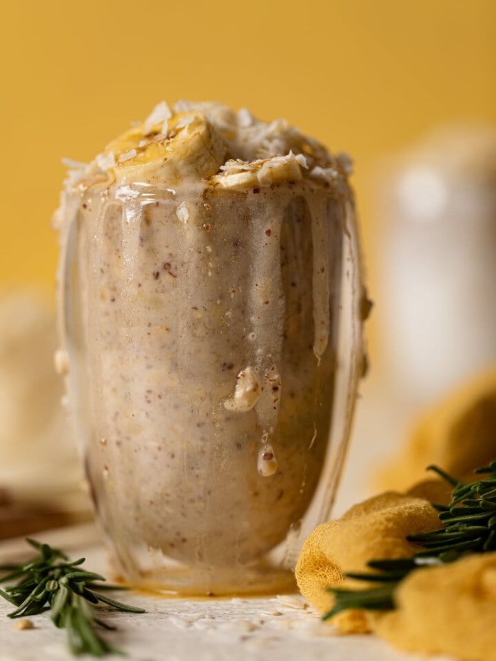 Overflowing glass of Banana Coconut Overnight Oats