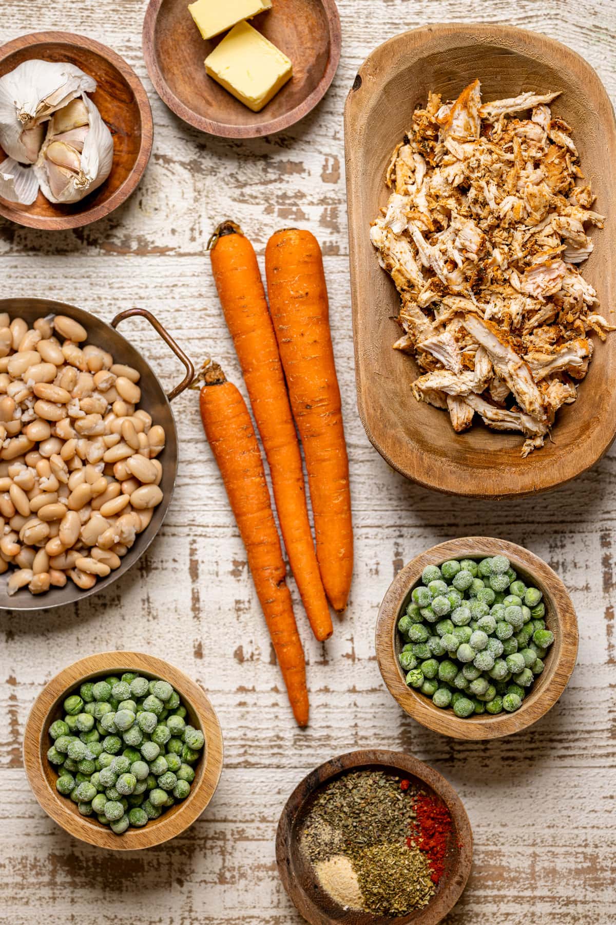 Ingredients for Chicken Pot Pie with Cheddar Herb Biscuits including peas, carrots, and garlic