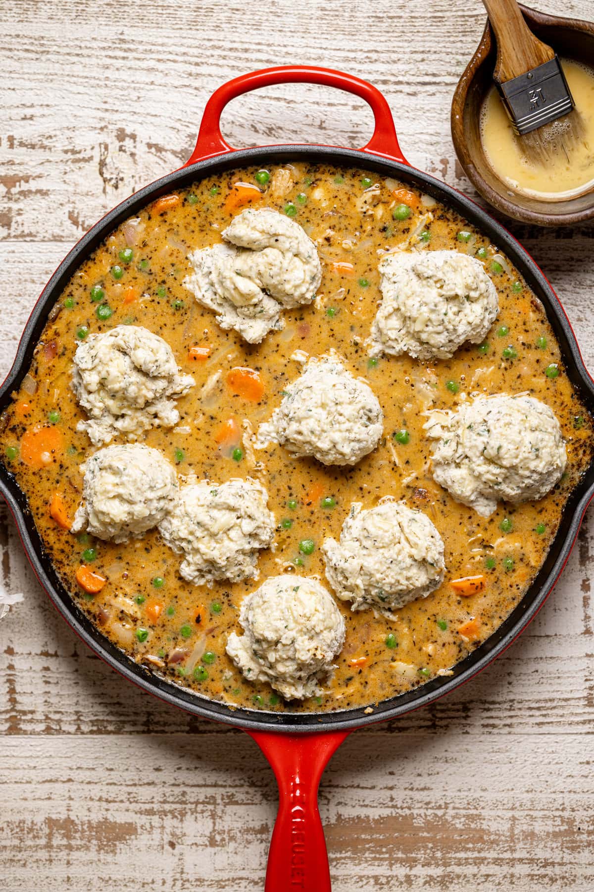 Skillet of Pie topped with dollops of Cheddar Herb Biscuit dough. The perfect weeknight dinner option.
