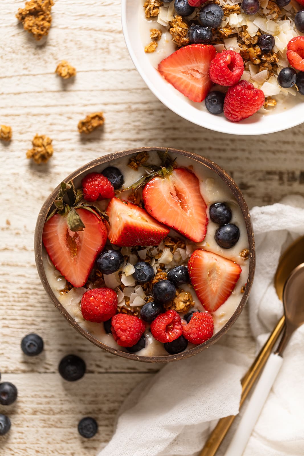 Overhead shot of a Coconut Berry Oatmeal Breakfast Bowl topped with lots of berries