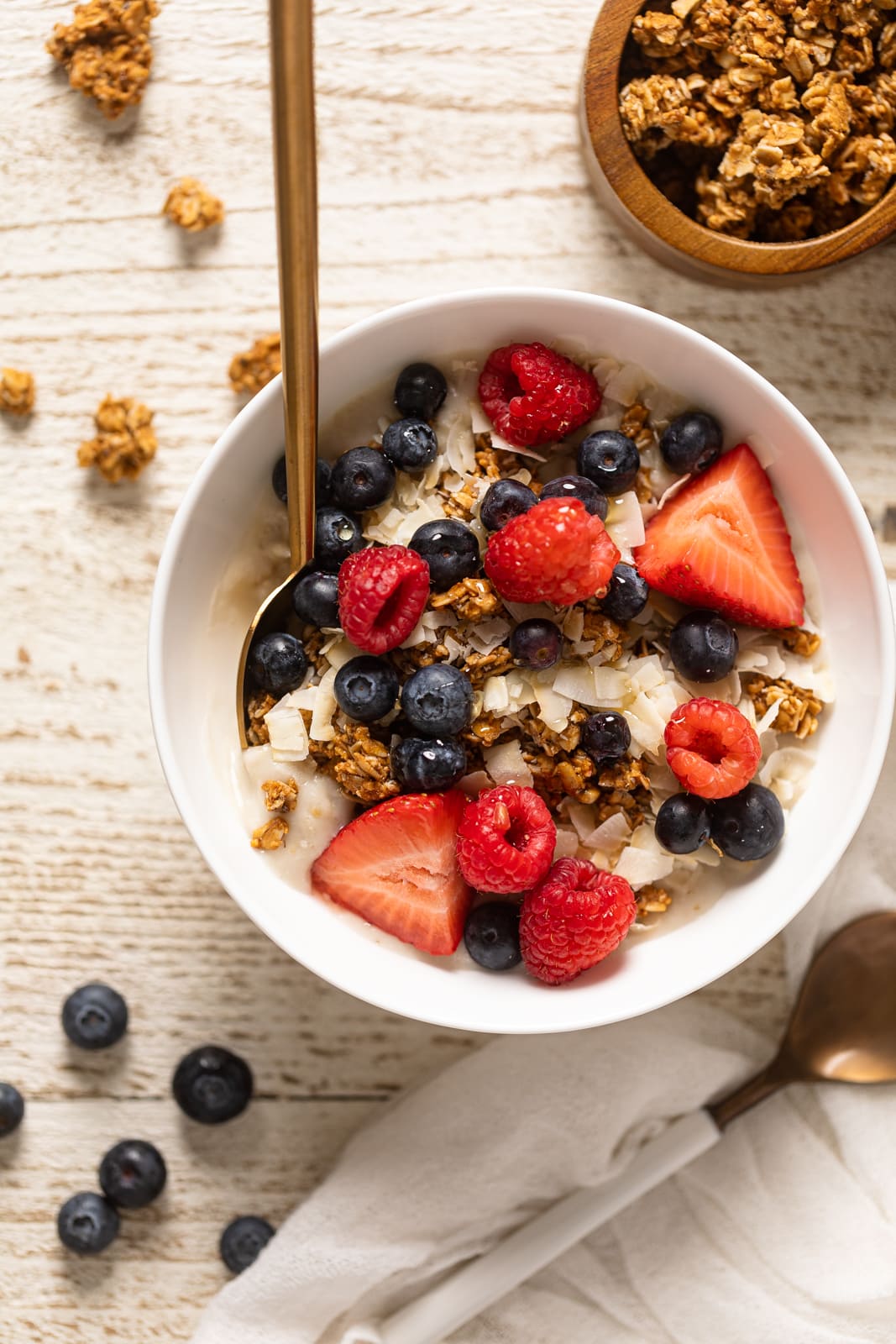 Overhead shot of a Coconut Berry Oatmeal Breakfast Bowl with a spoon