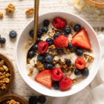 Overhead shot of a Coconut Berry Oatmeal Breakfast Bowl with a spoon