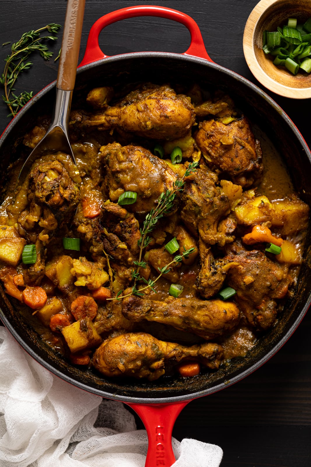 Overhead shot of a skillet of Jamaican Curry Chicken 