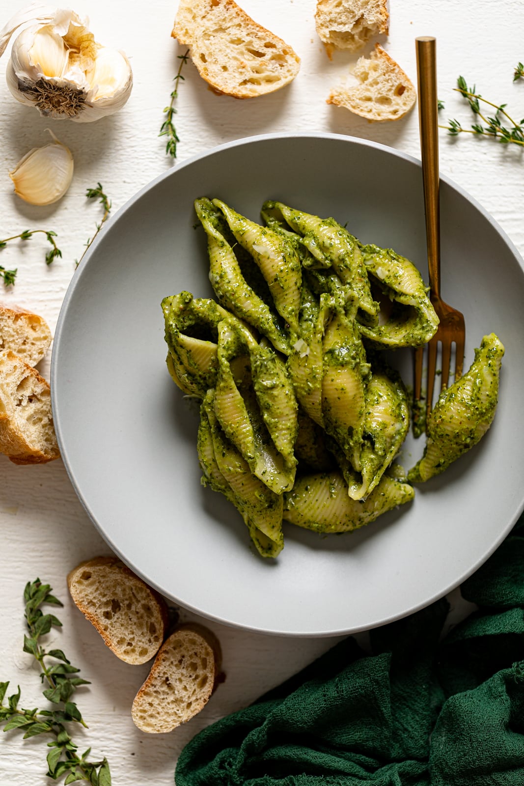 Overhead shot of a plate of Creamy Roasted Garlic Kale Pasta with Parmesan with a fork