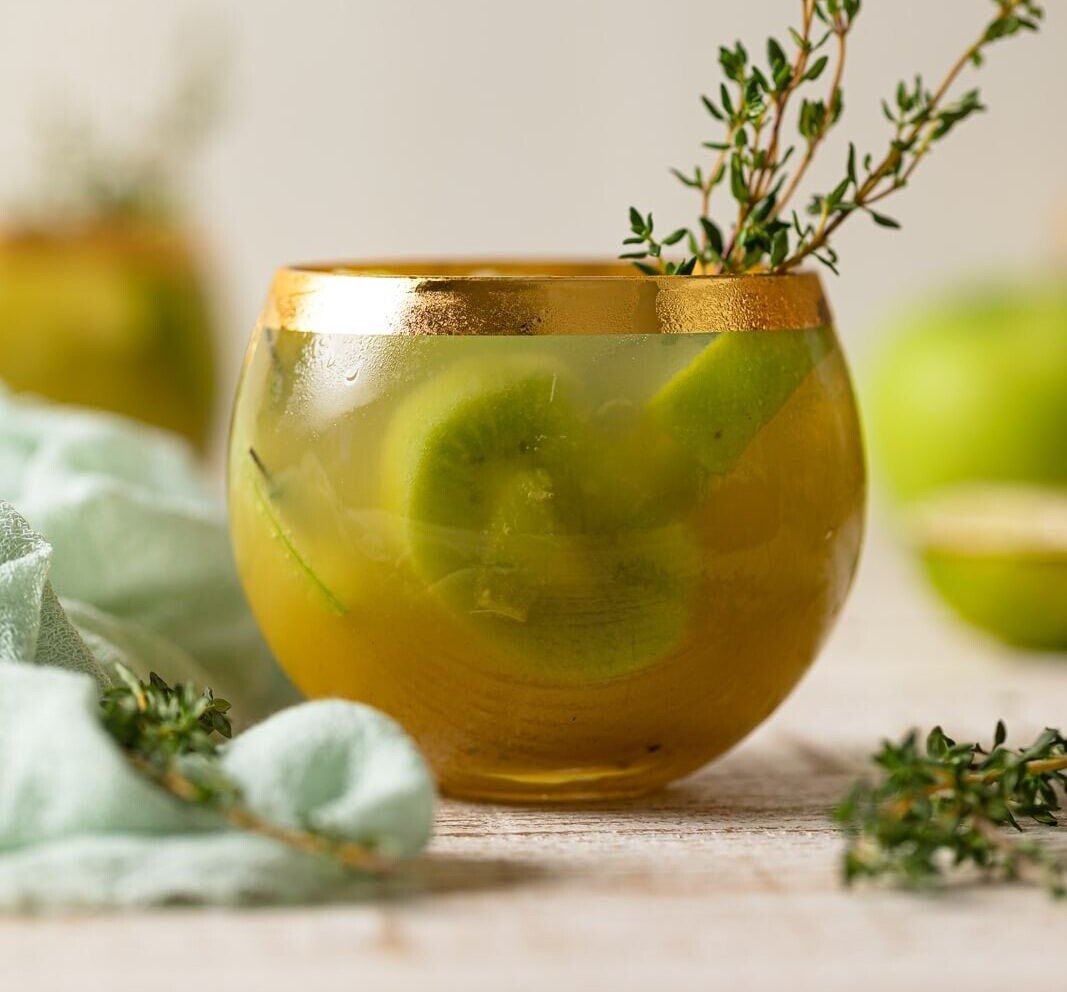 Green Goddess Mocktail in a gold-rimmed glass