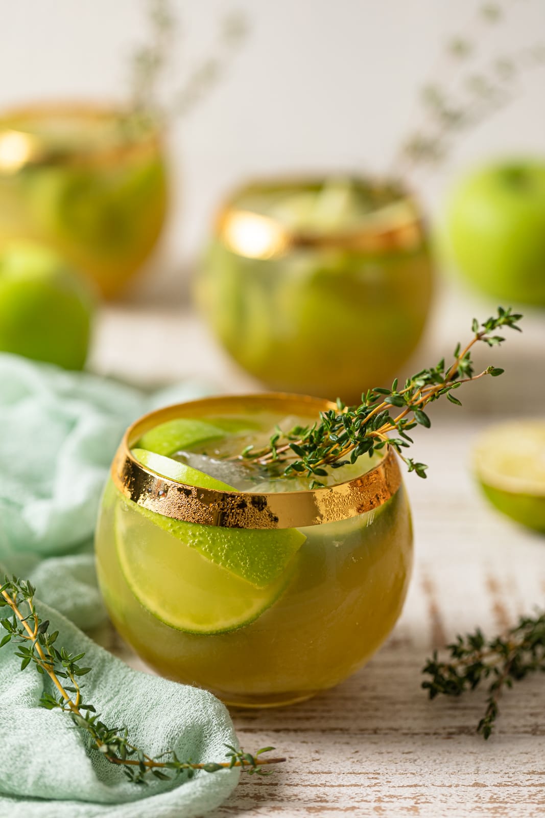 Several Green Goddess Mocktails in gold-rimmed glasses