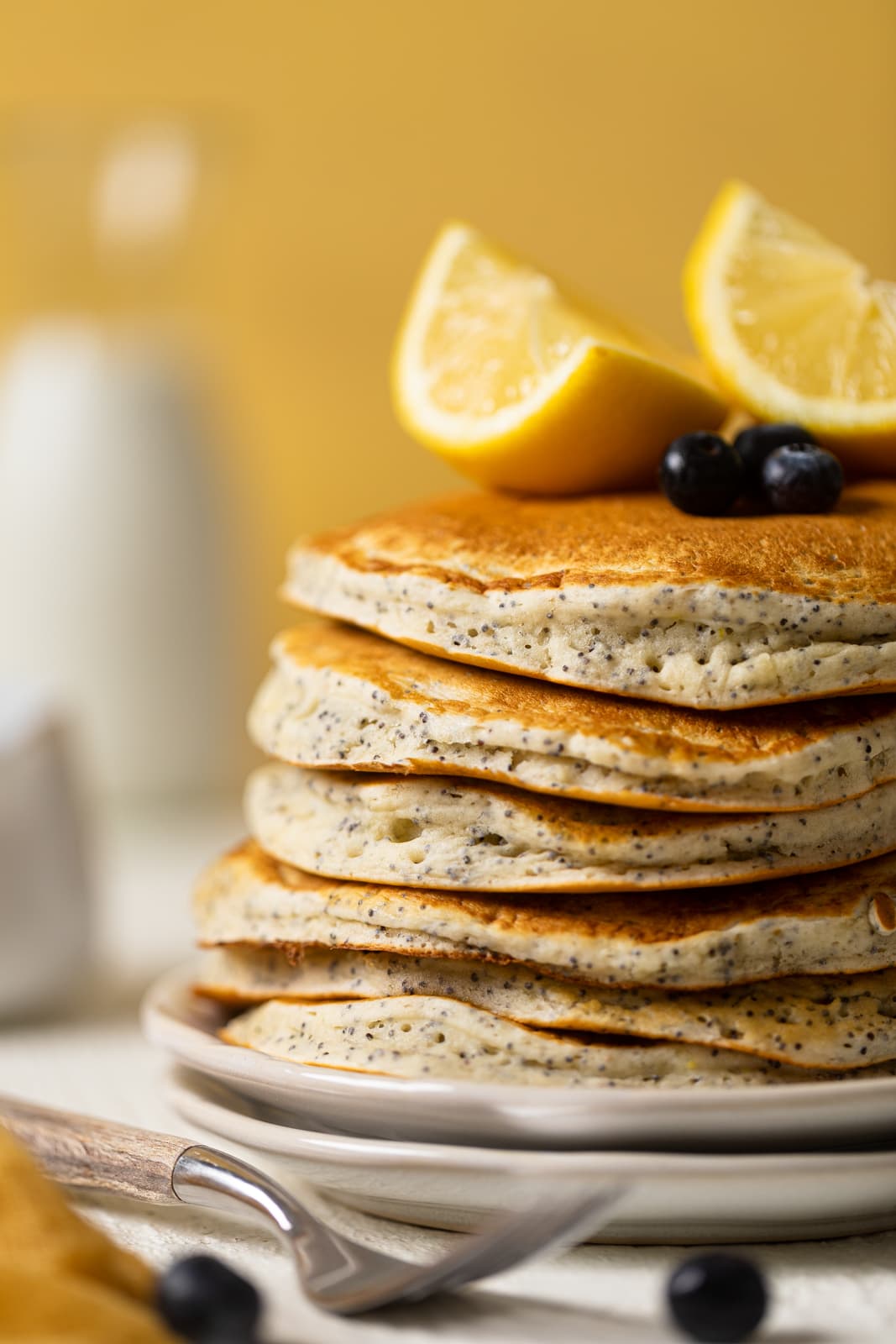Closeup of a stack of Vegan Lemon Poppyseed Pancakes