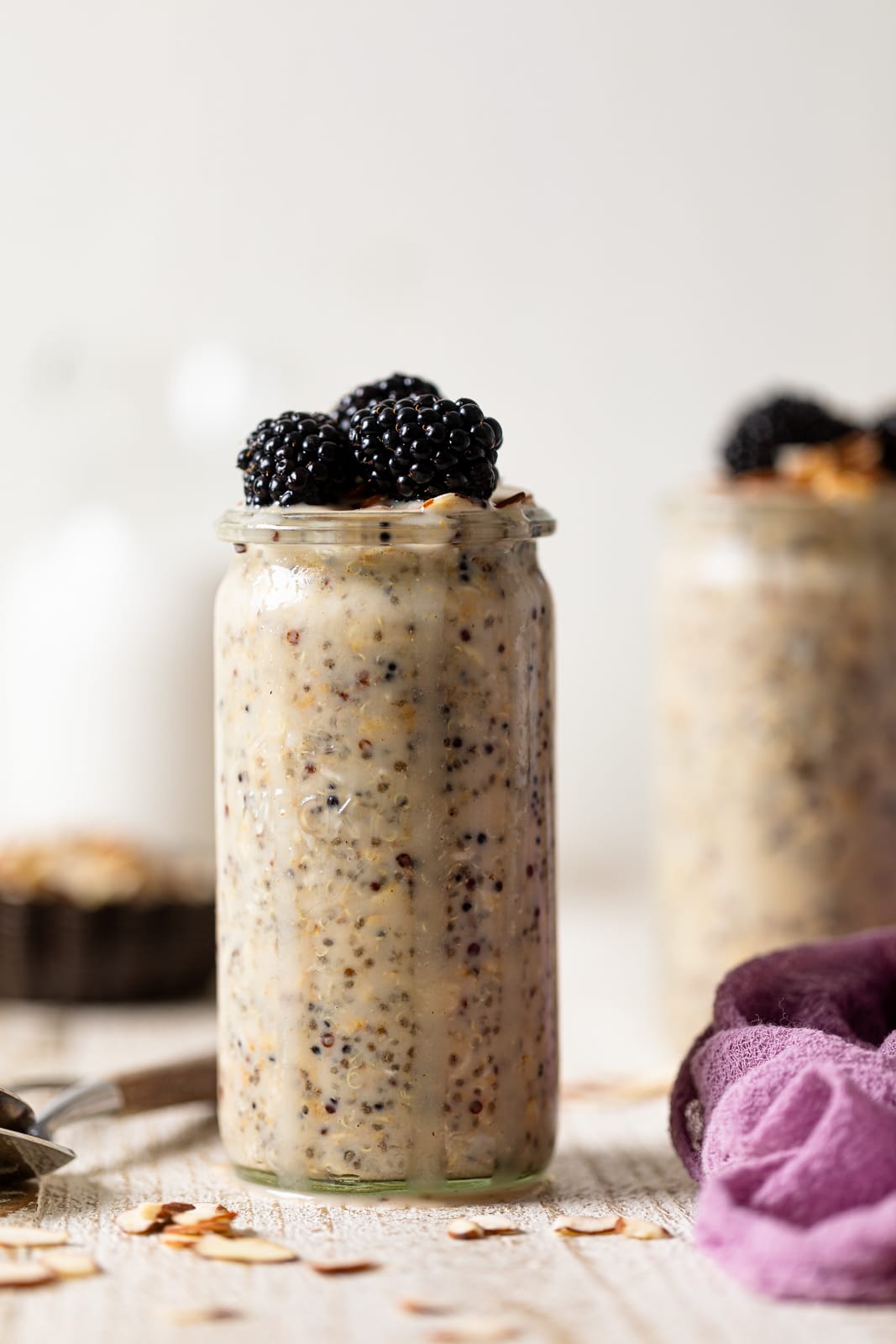 Glass of Protein Overnight Quinoa topped with blackberries