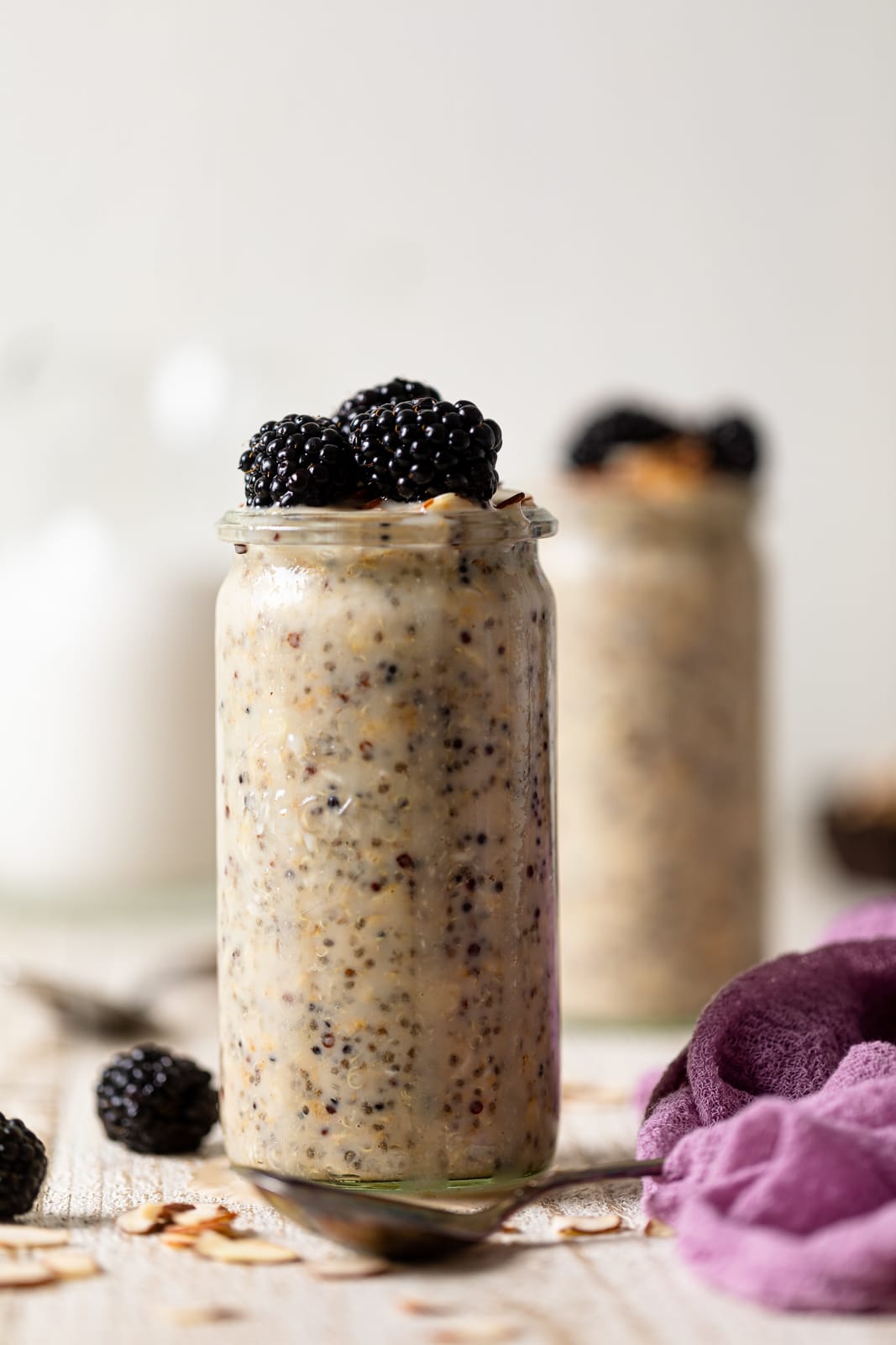 Glass of Protein Overnight Quinoa topped with blackberries