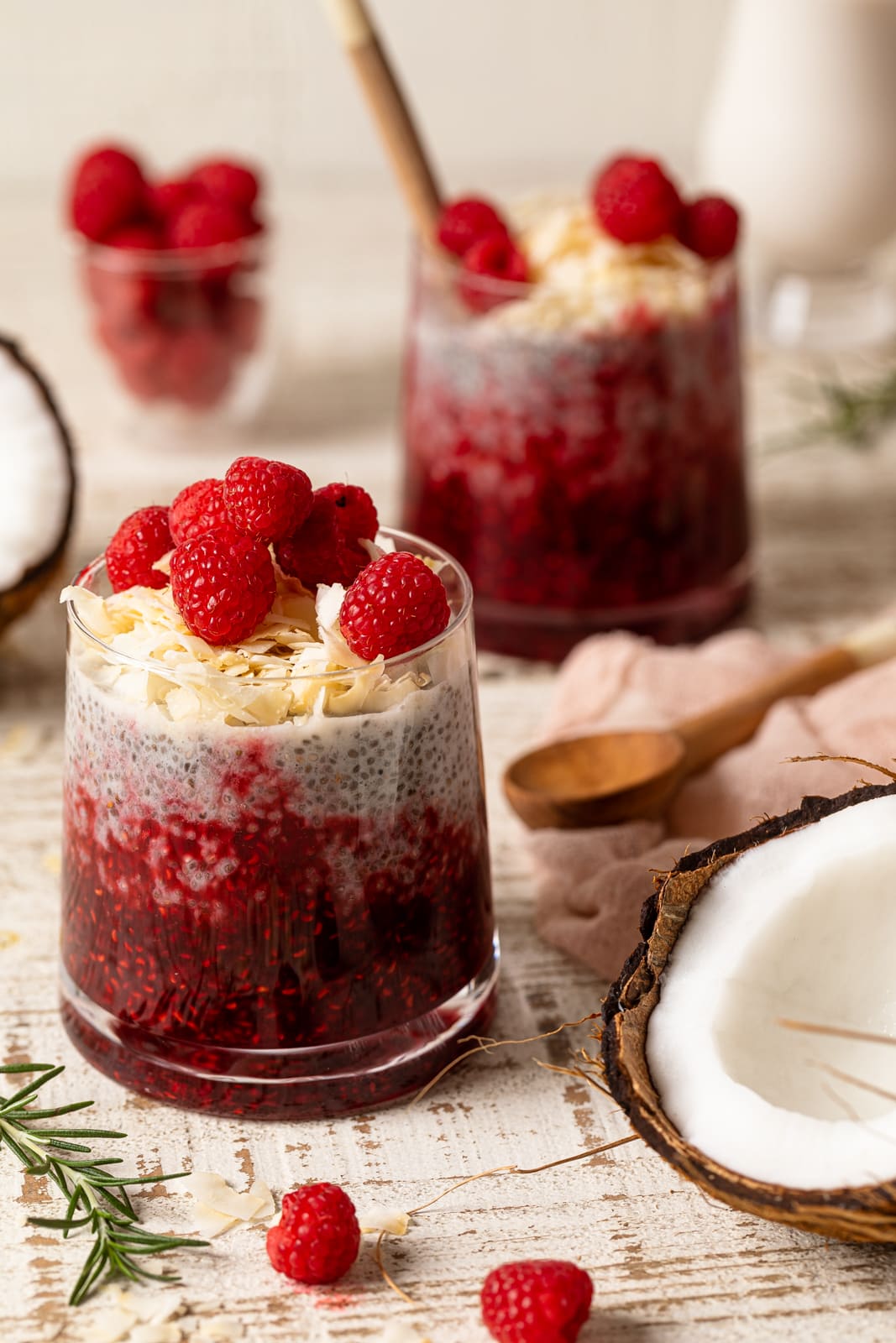 Several small glasses of Coconut Raspberry Chia Pudding