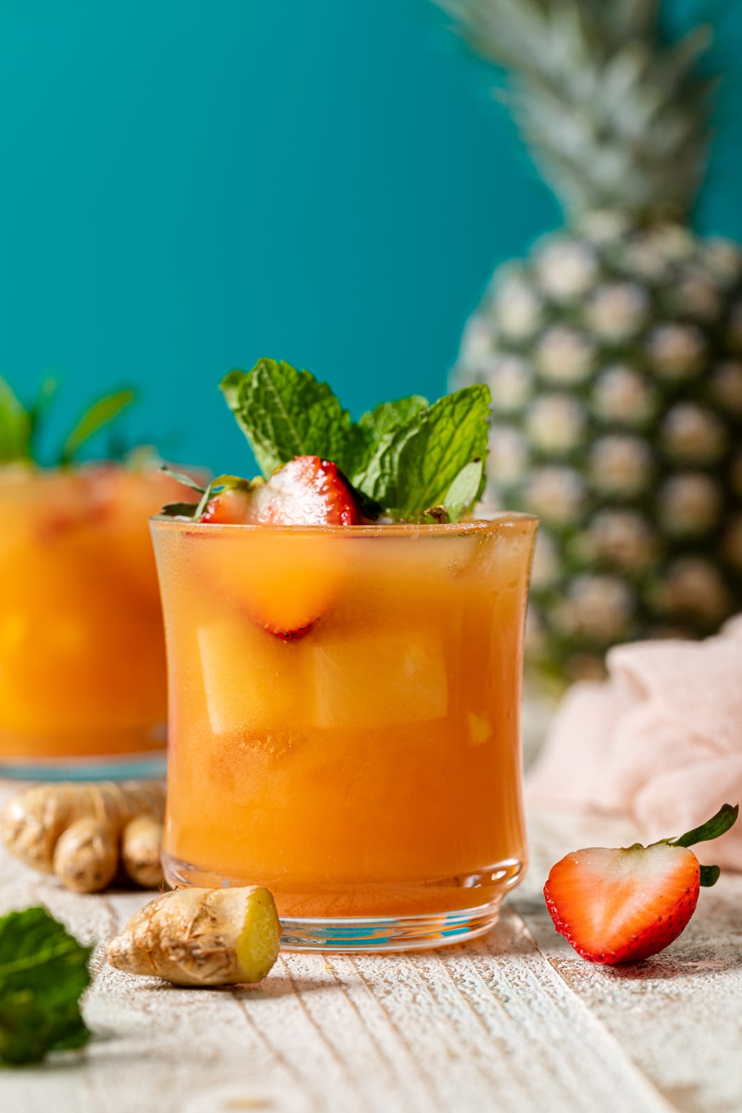 Jamaican Rum Punch Mocktail in a glass in front of a pineapple
