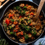 Overhead shot of Spicy Veggie Quinoa Skillet with a wooden spoon
