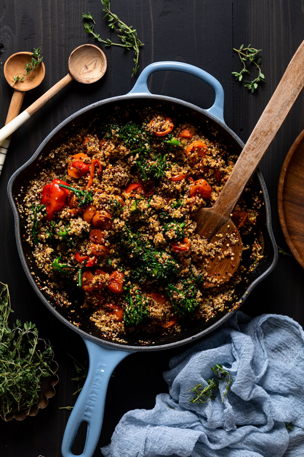 Wooden spoon in a Spicy Veggie Quinoa Skillet