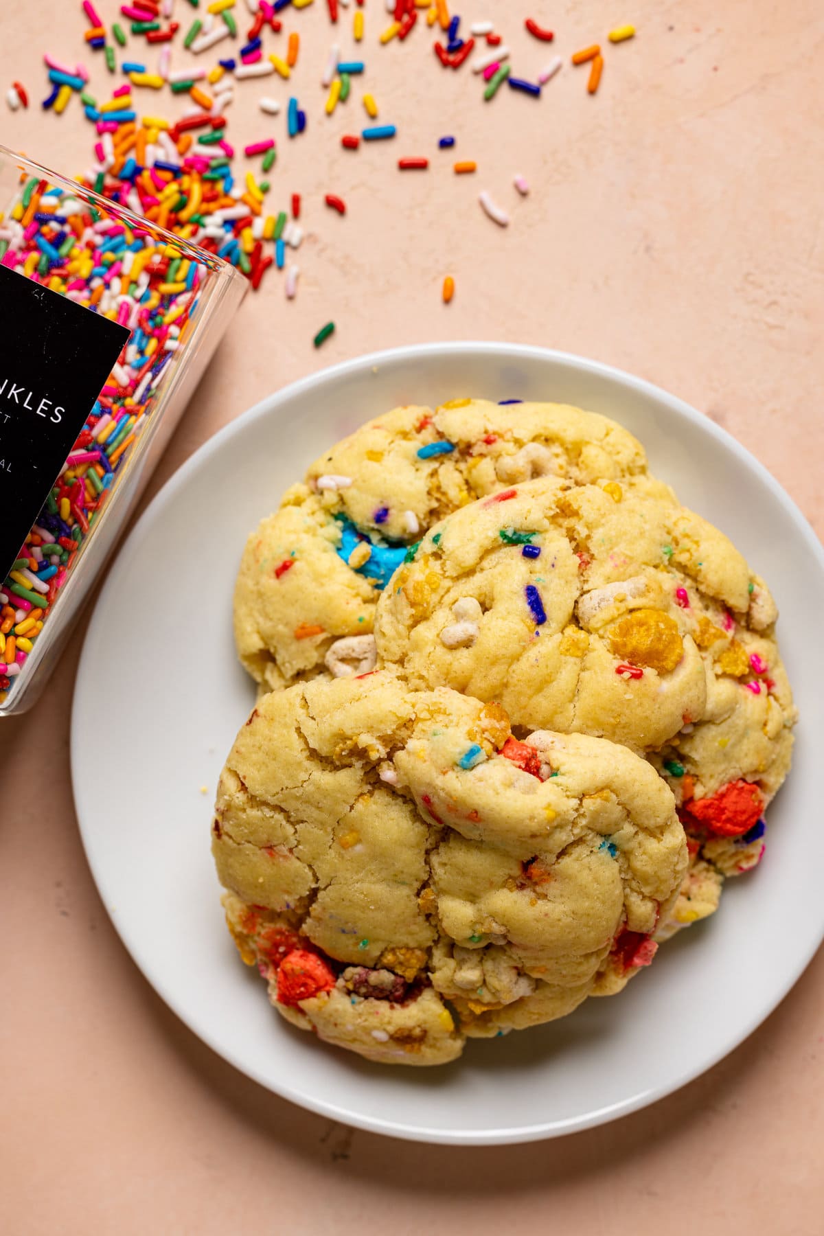 Plate of cookies next to sprinkles