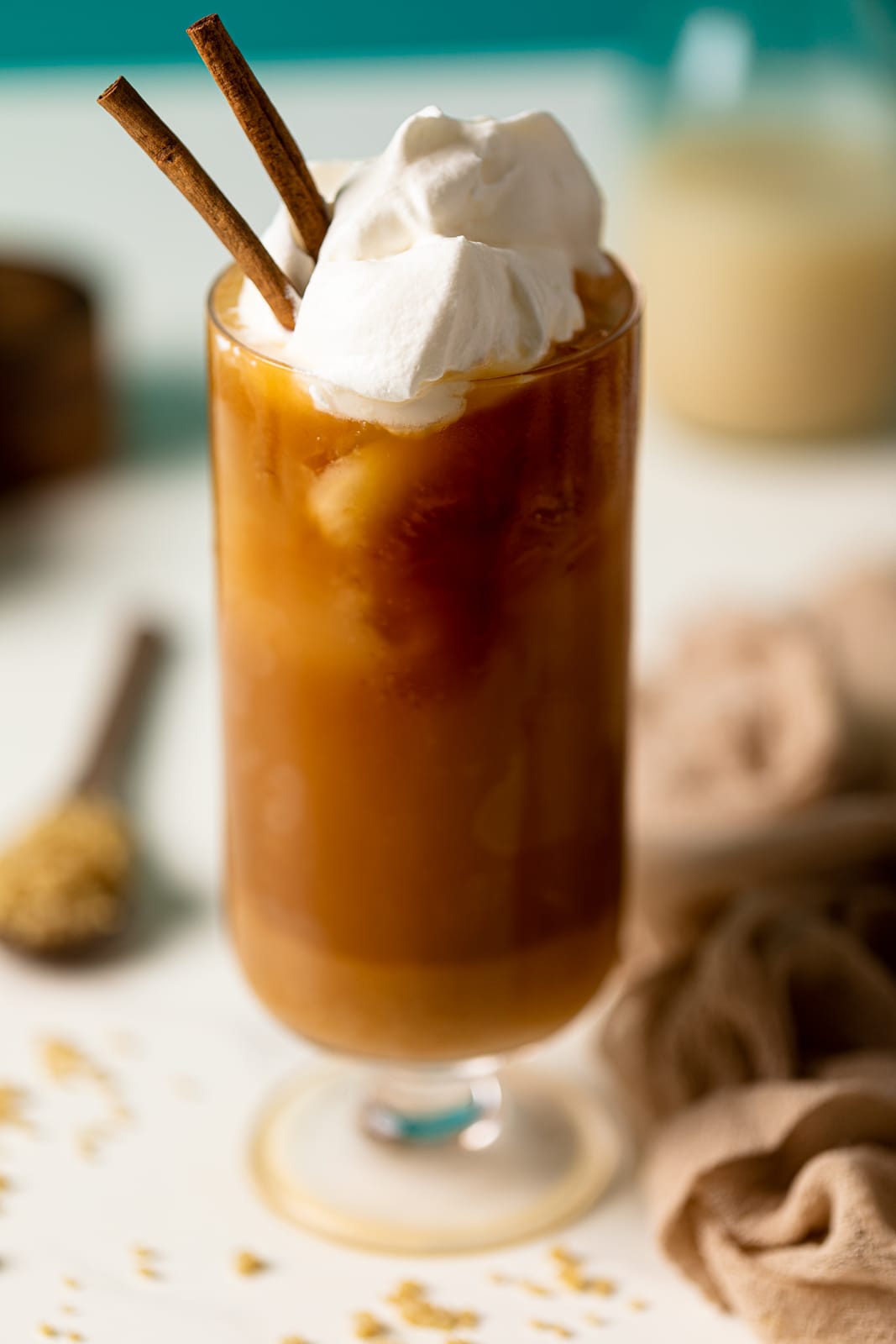 Iced Vanilla Latte with Quinoa Milk topped with coconut whipped cream and cinnamon sticks