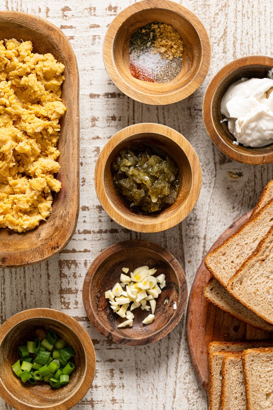 Ingredients for Vegan Chickpea Tuna Melt Sandwiches including garlic, green onions, and bread