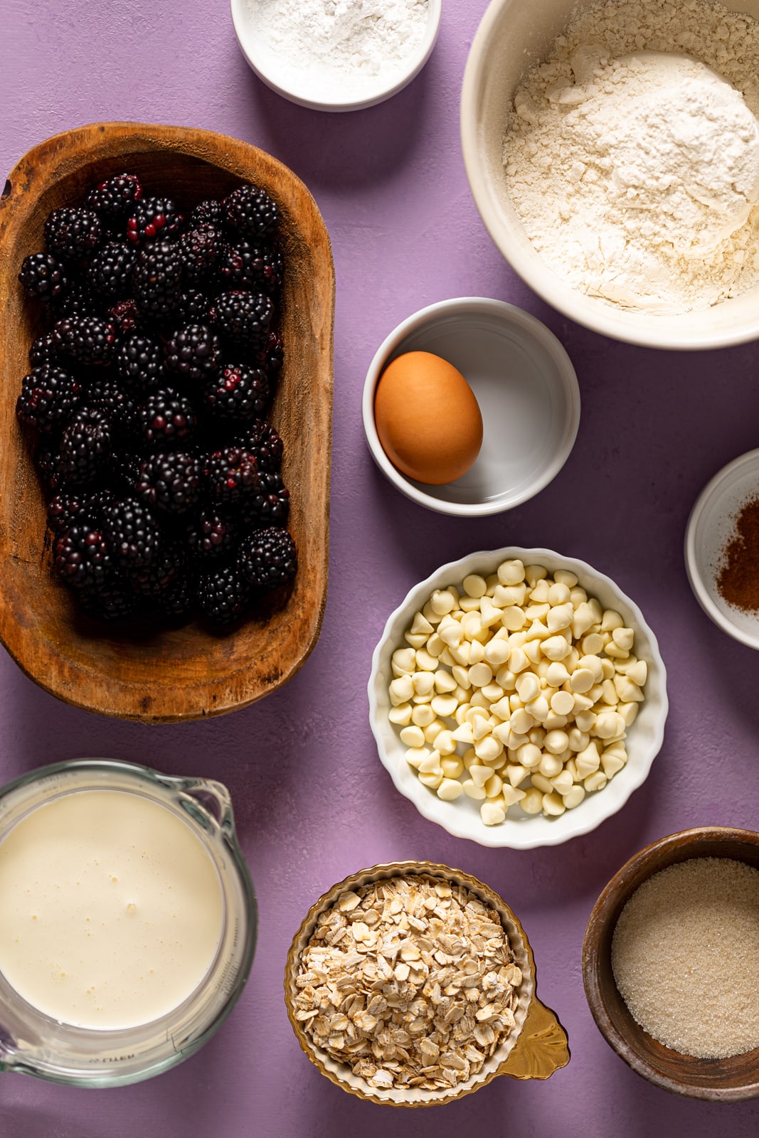 Ingredients for Blackberry White Chocolate Oatmeal Scones including egg, blackberries, and oats