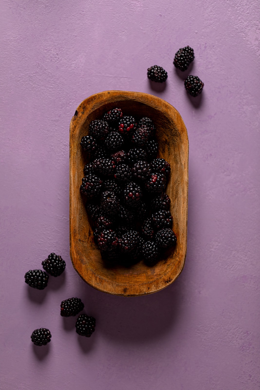 Wooden bowl of blackberries