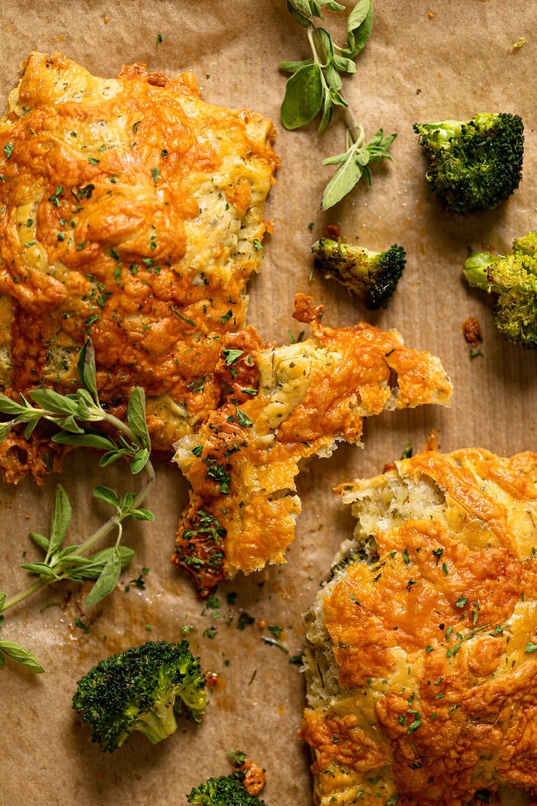 Closeup of Broccoli Cheddar Hand Pies with one broken apart