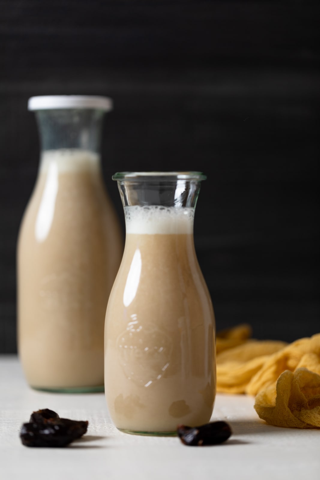 Two glass jars of Cauliflower Milk, the smaller of which is in the foreground