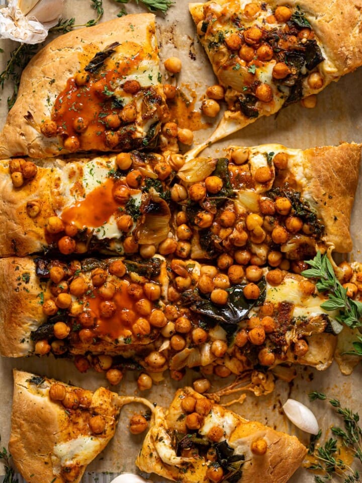 Overhead shot of a sliced Sheet Pan Roasted Garlic Buffalo Chickpea Pizza