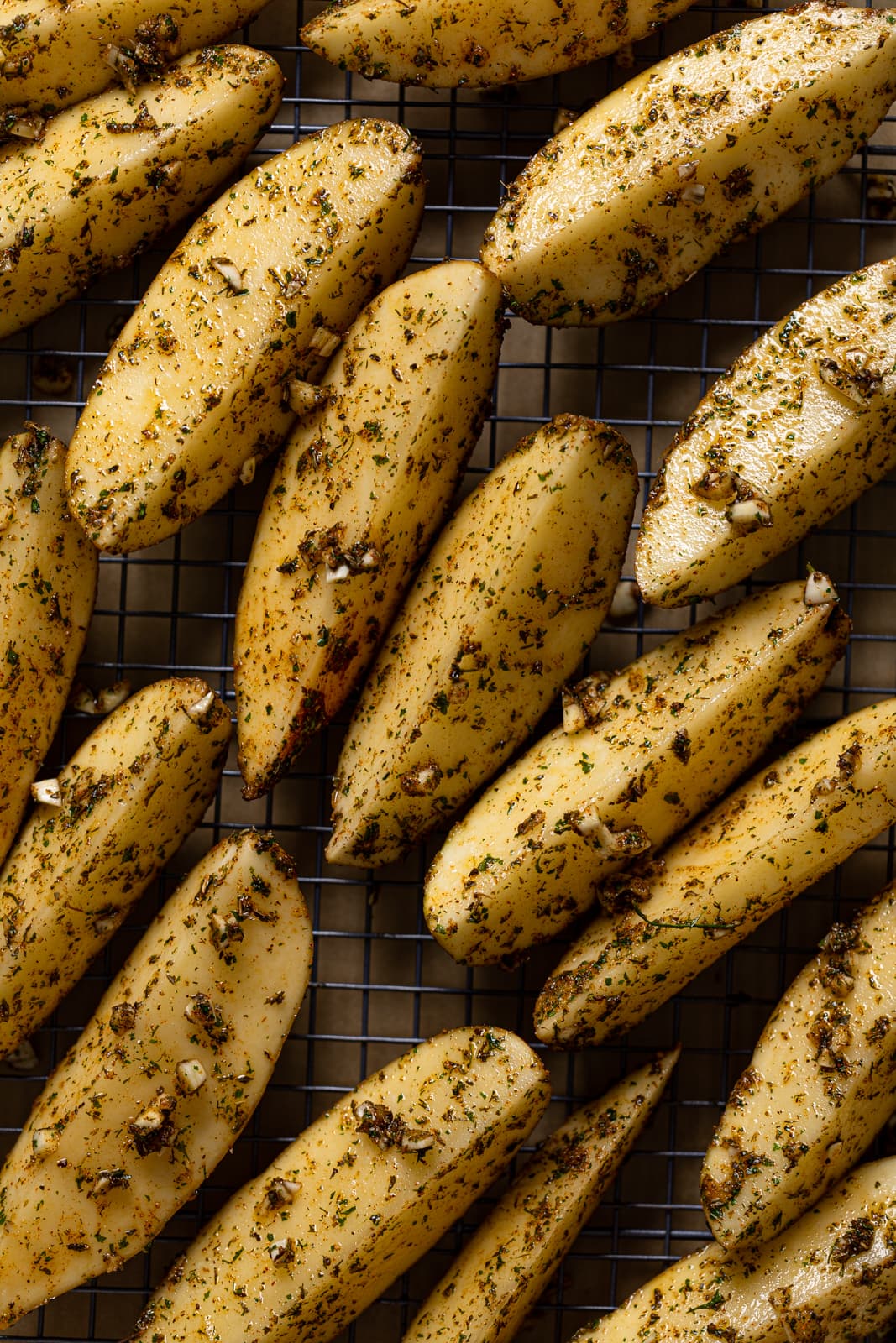 Seasoned potato wedges on a wire rack