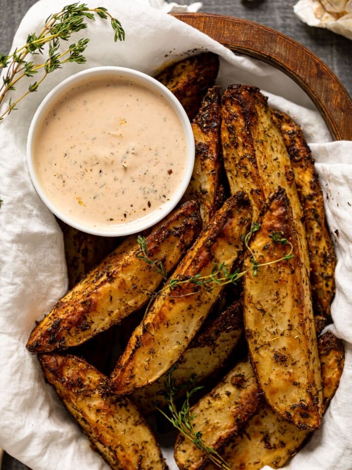 Basket of Crispy Garlic Herb Fries with dip