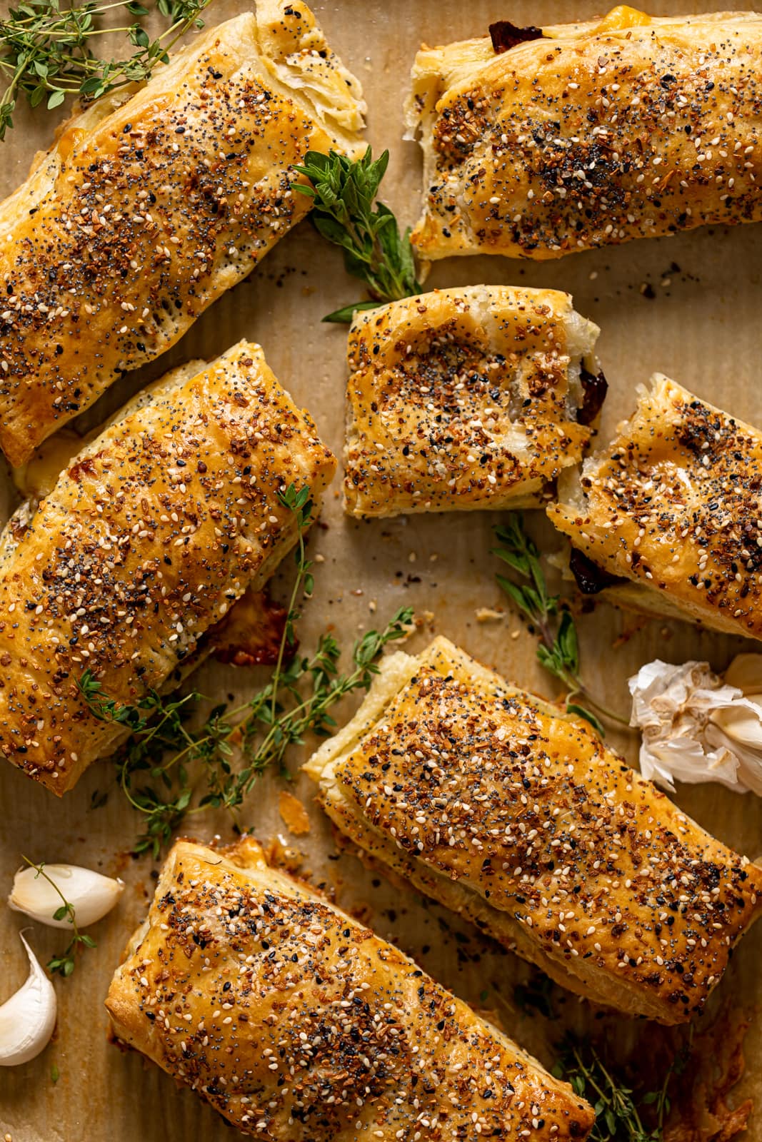 Several Everything Brussels Sprouts and Mozzarella Hand Pies on parchment paper