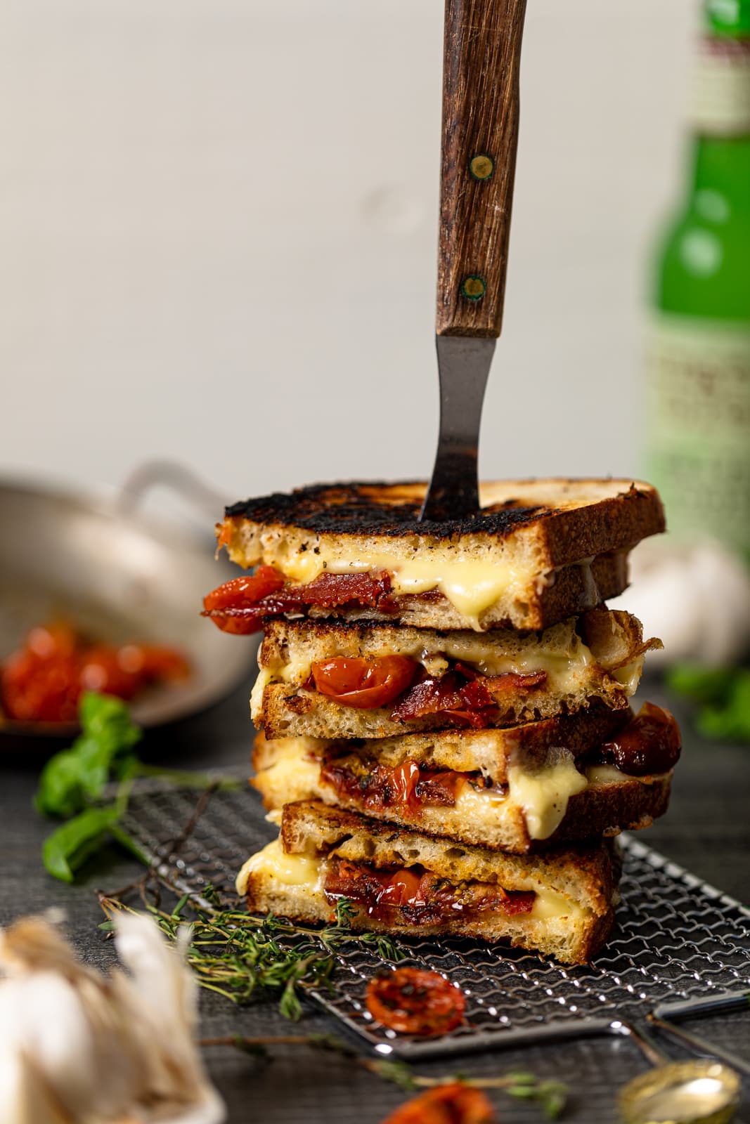 Stack of Southern-Style Bacon Grilled Cheese Sandwiches skewered and on a wire rack