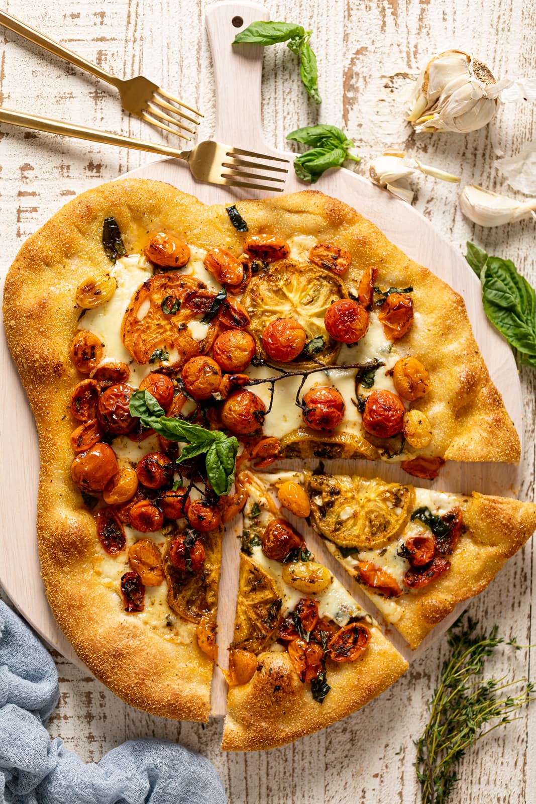 Partially-sliced Herbed Butter Tomato Pizza
