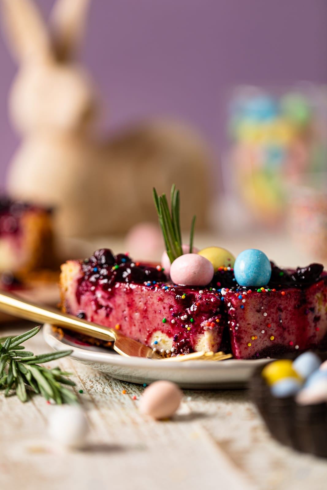 Slice of Lemon Blueberry Cheesecake topped with pastel Easter egg candies