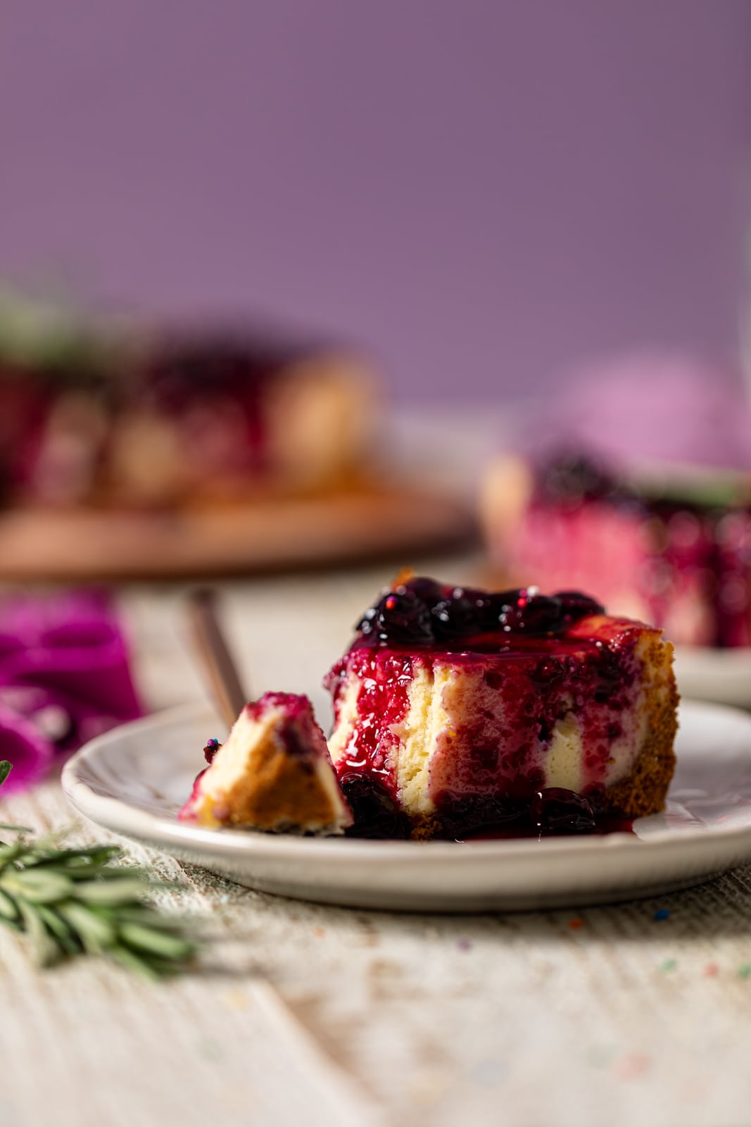 Slice of Perfect Lemon Blueberry Cheesecake on a plate