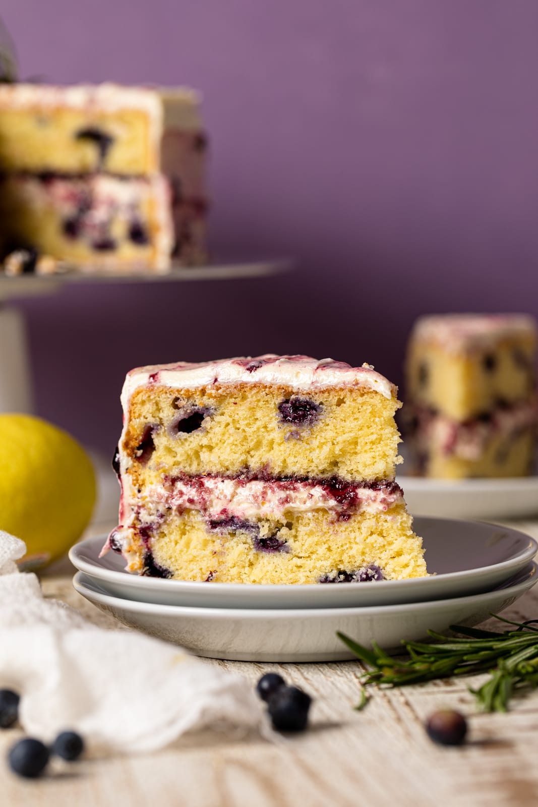 Slice of Lemon Blueberry Olive Oil Cake on two small stacked plates