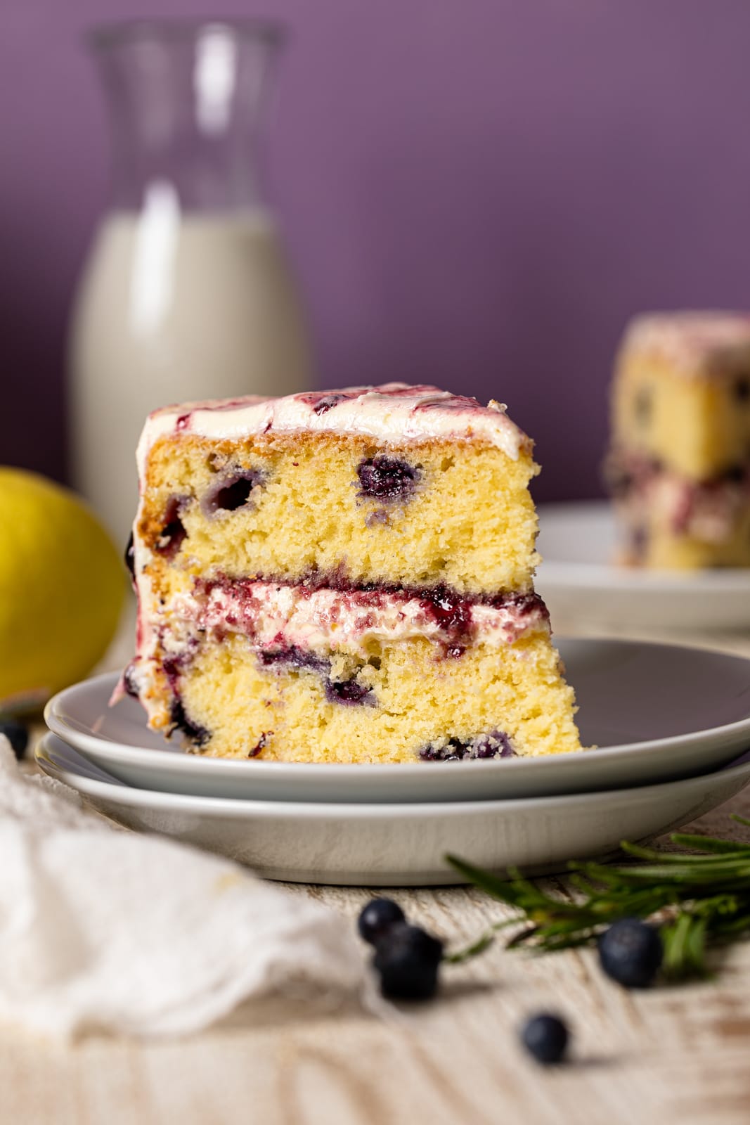 Slice of Lemon Blueberry Olive Oil Cake on two small stacked plates