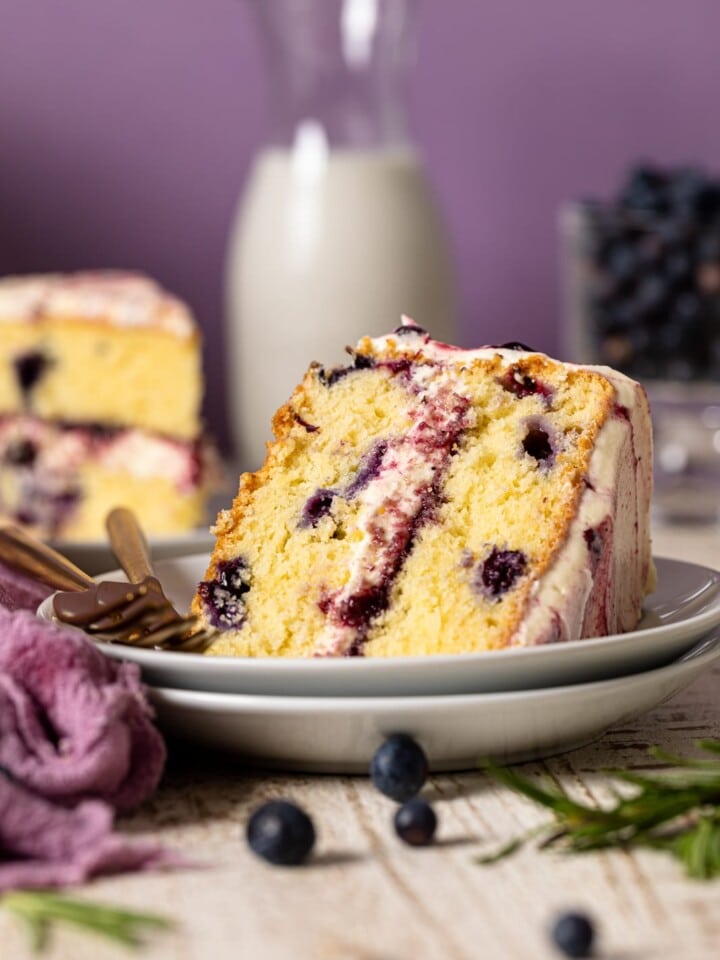 Slice of Lemon Blueberry Olive Oil Cake on two stacked plates