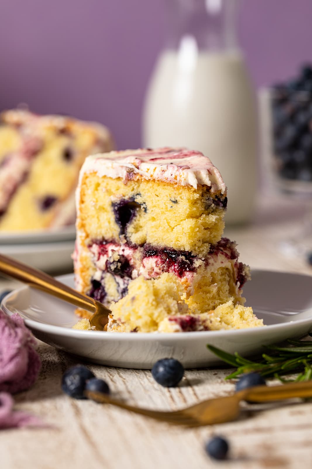 Slice of Lemon Blueberry Olive Oil Cake with a fork on a plate