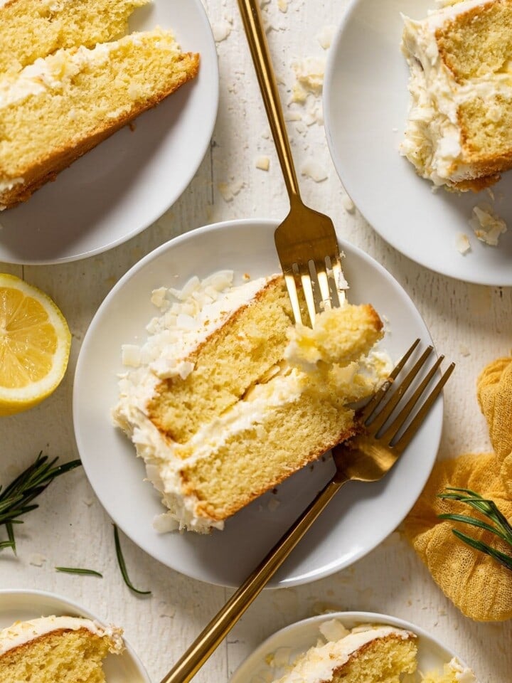 Slice of Lemon Coconut Cake with two forks on a small plate