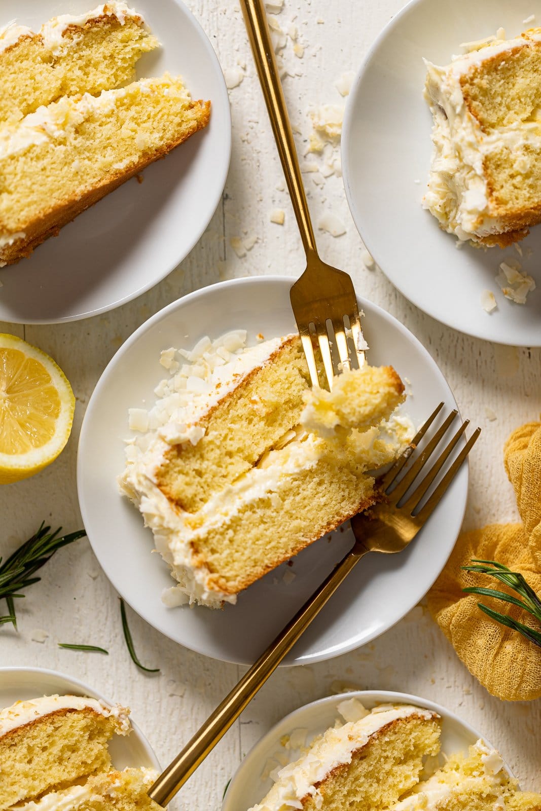 Slice of Lemon Coconut Cake with two forks on a small plate