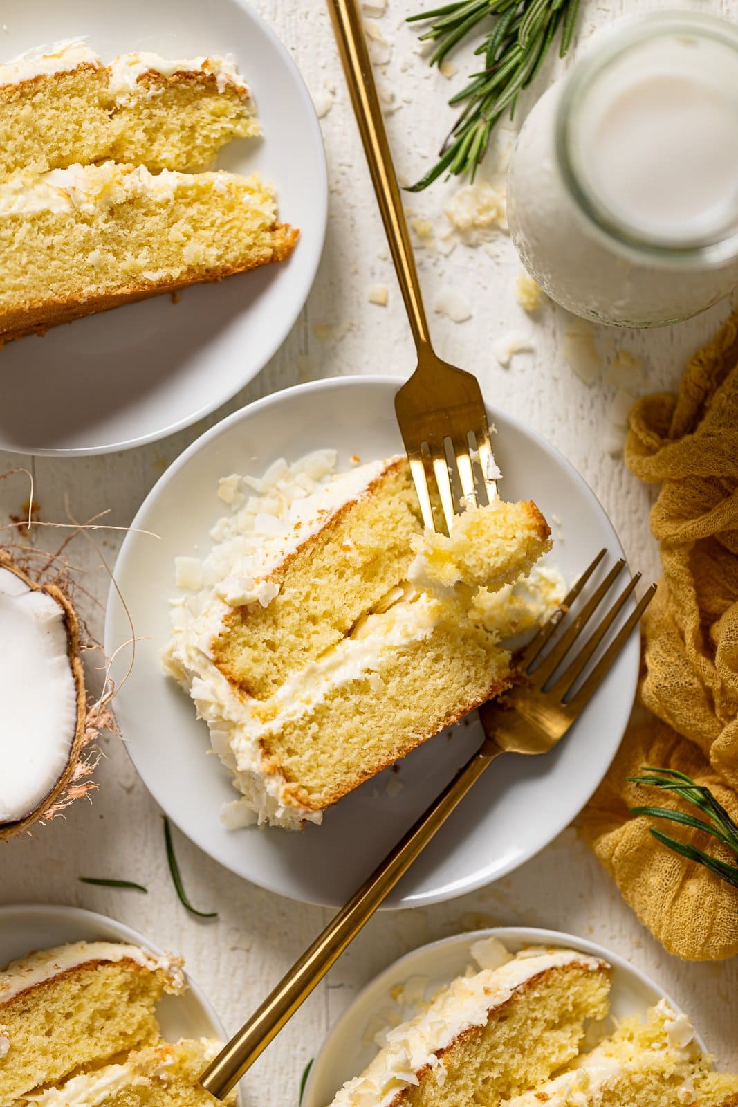 Overhead shot of a slice of Lemon Coconut easter Cake with two forks on a small plate