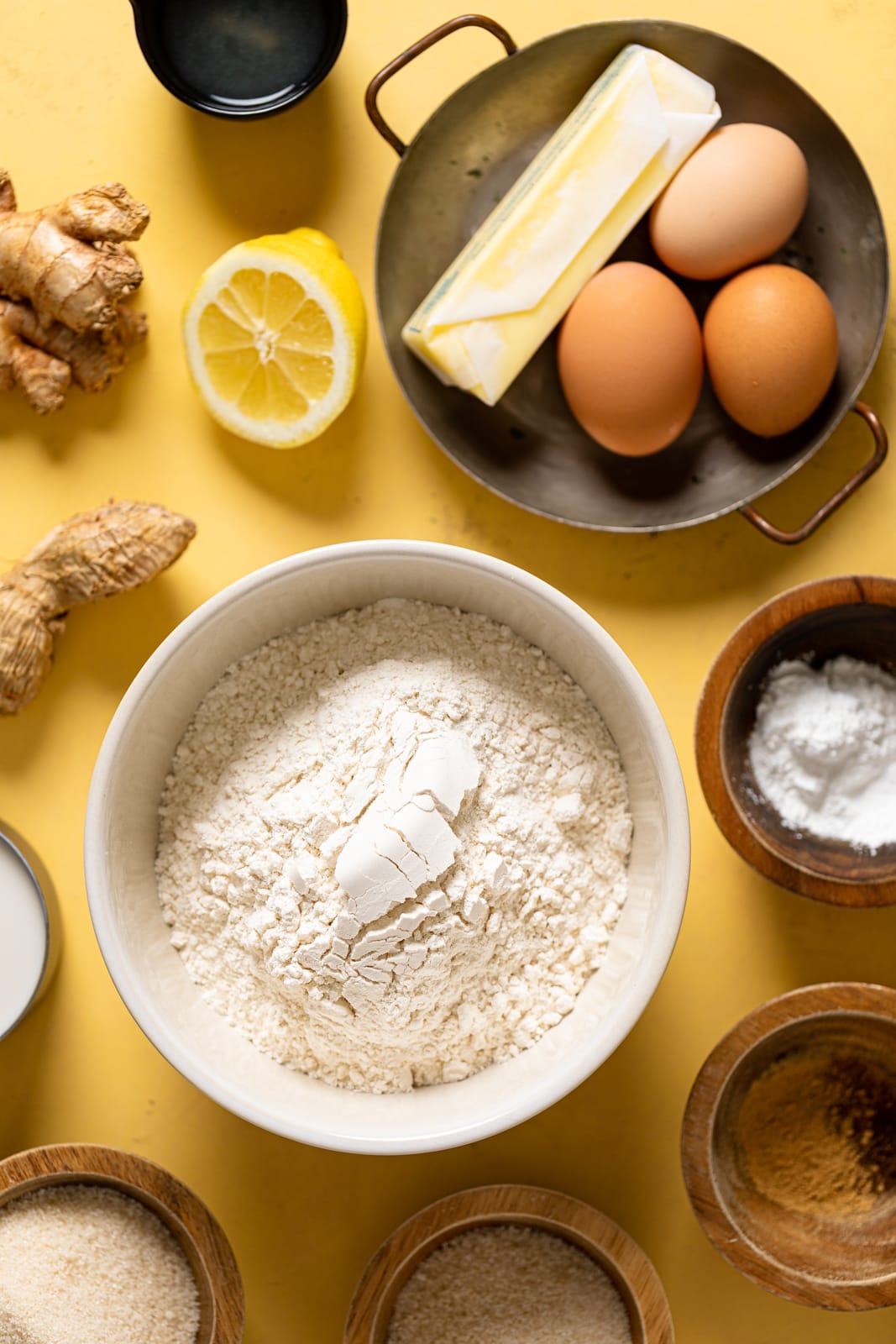 Ingredients for Lemon Ginger Bundt Cake including eggs, ginger, and flour