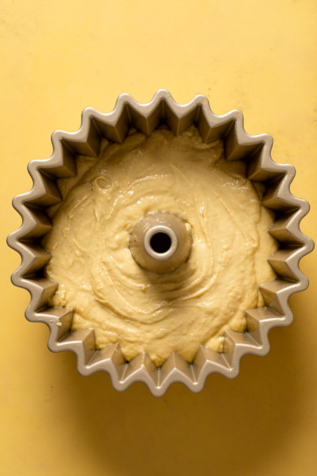 Bundt Cake pan filled with lemon ginger bundt cake batter