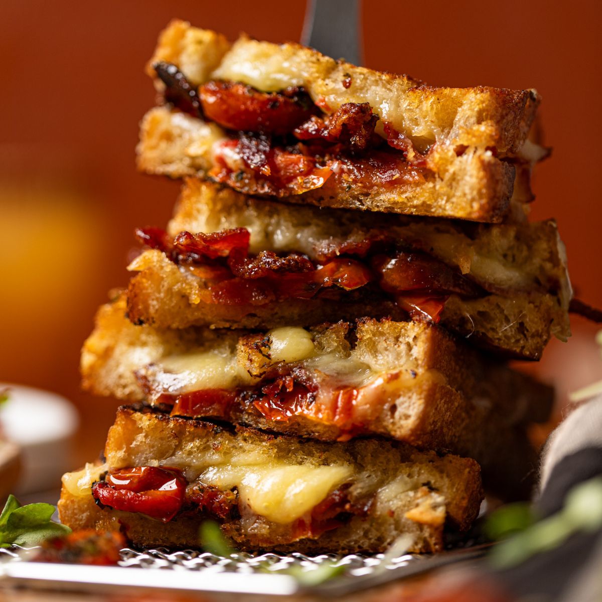 Up close shot of stacked grilled cheese sandwiches.