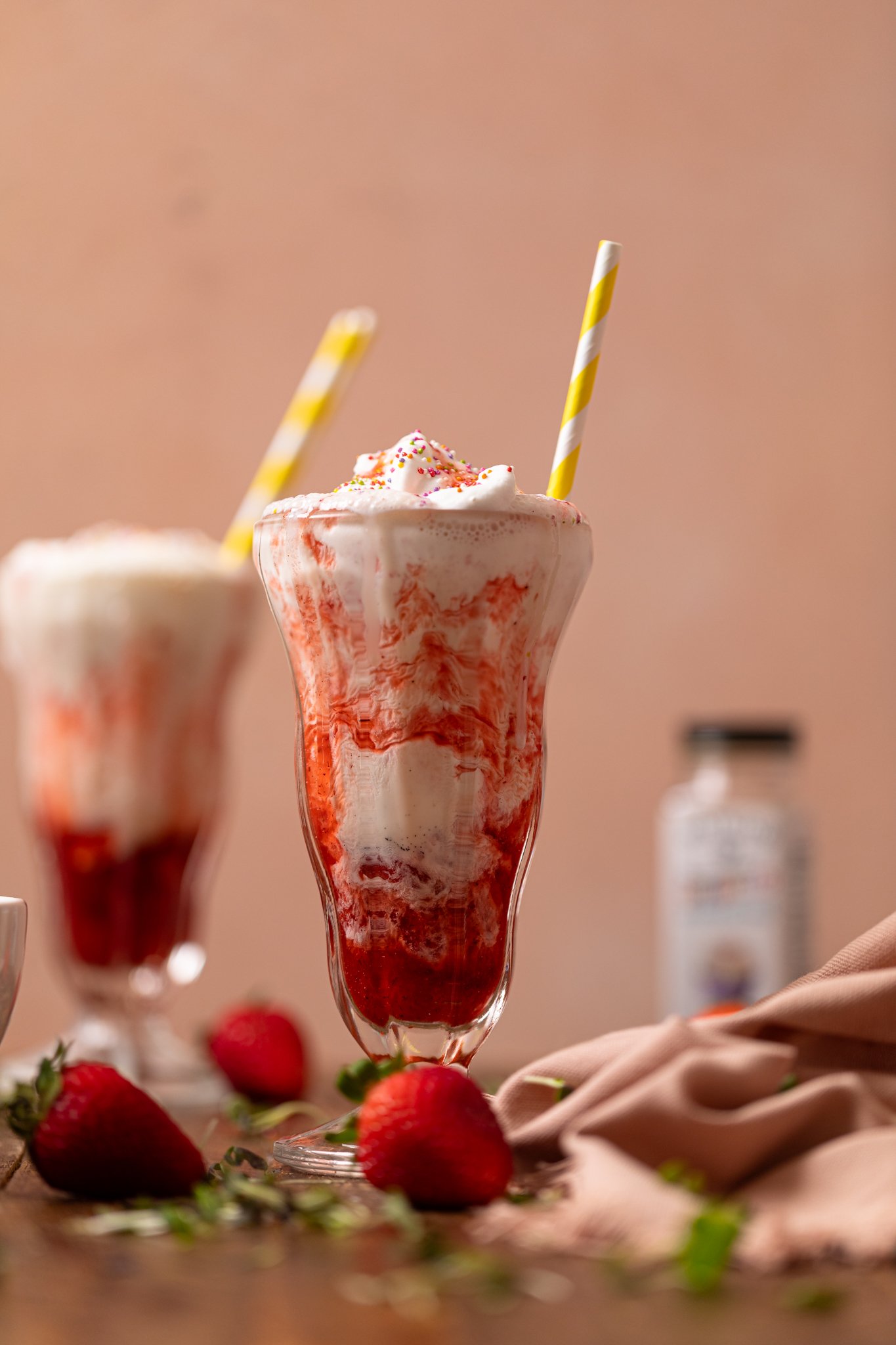 Insanely Good Strawberry Milkshake [Dairy-Free] in two glasses with straws.