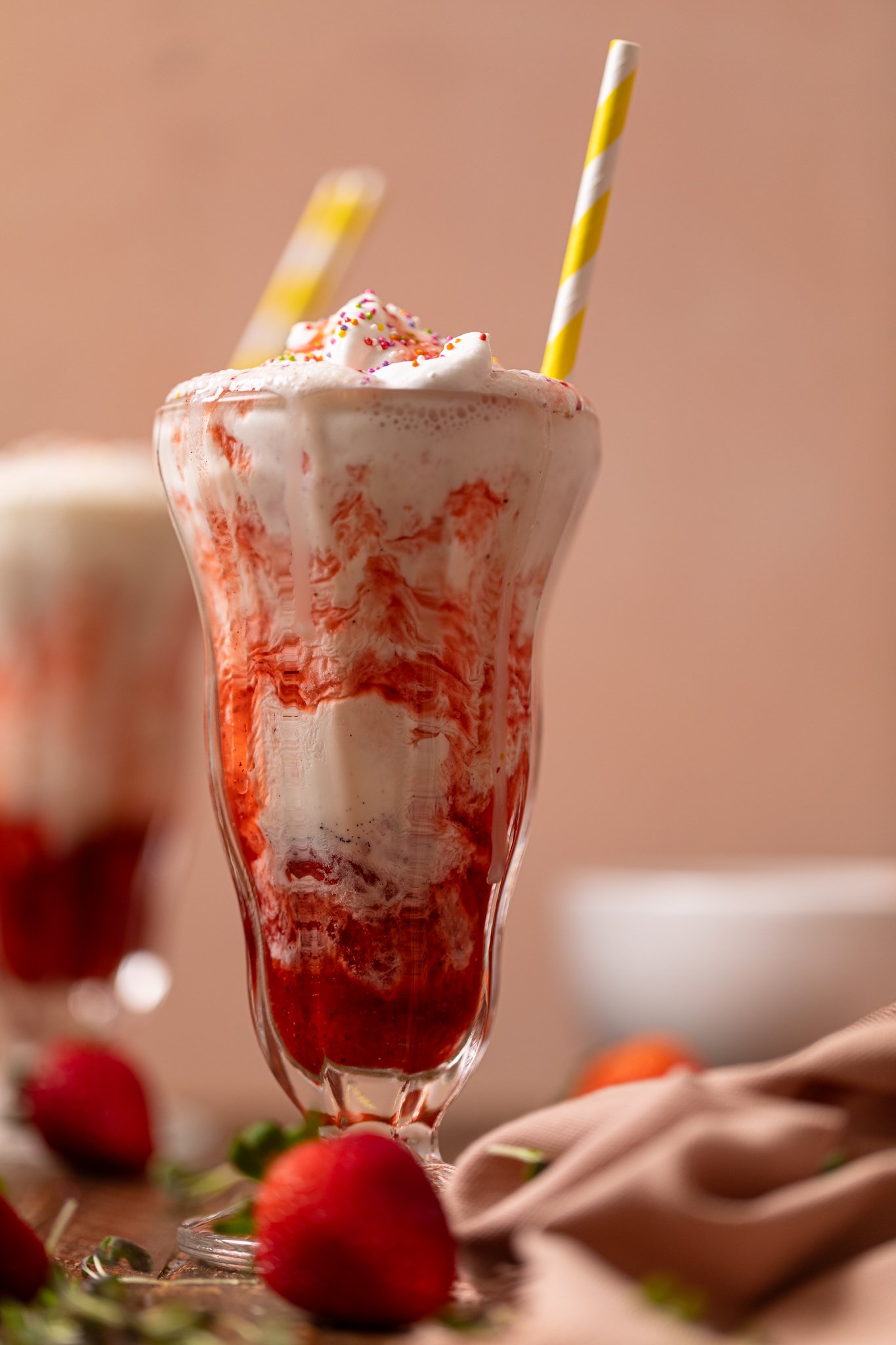 Insanely Good Strawberry Milkshake [Dairy-Free] in glasses with strawberries. 