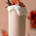 Closeup of a glass overflowing with Dairy-Free Strawberry Milkshake