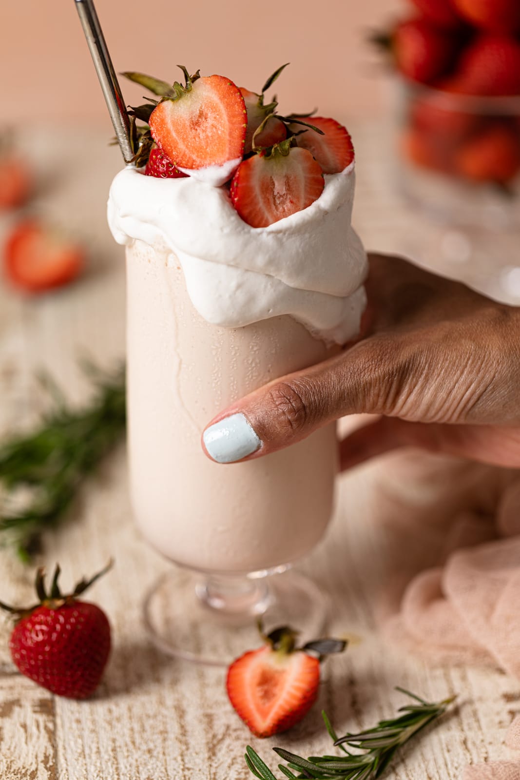 Hand grabbing a Dairy-Free Strawberry Milkshake