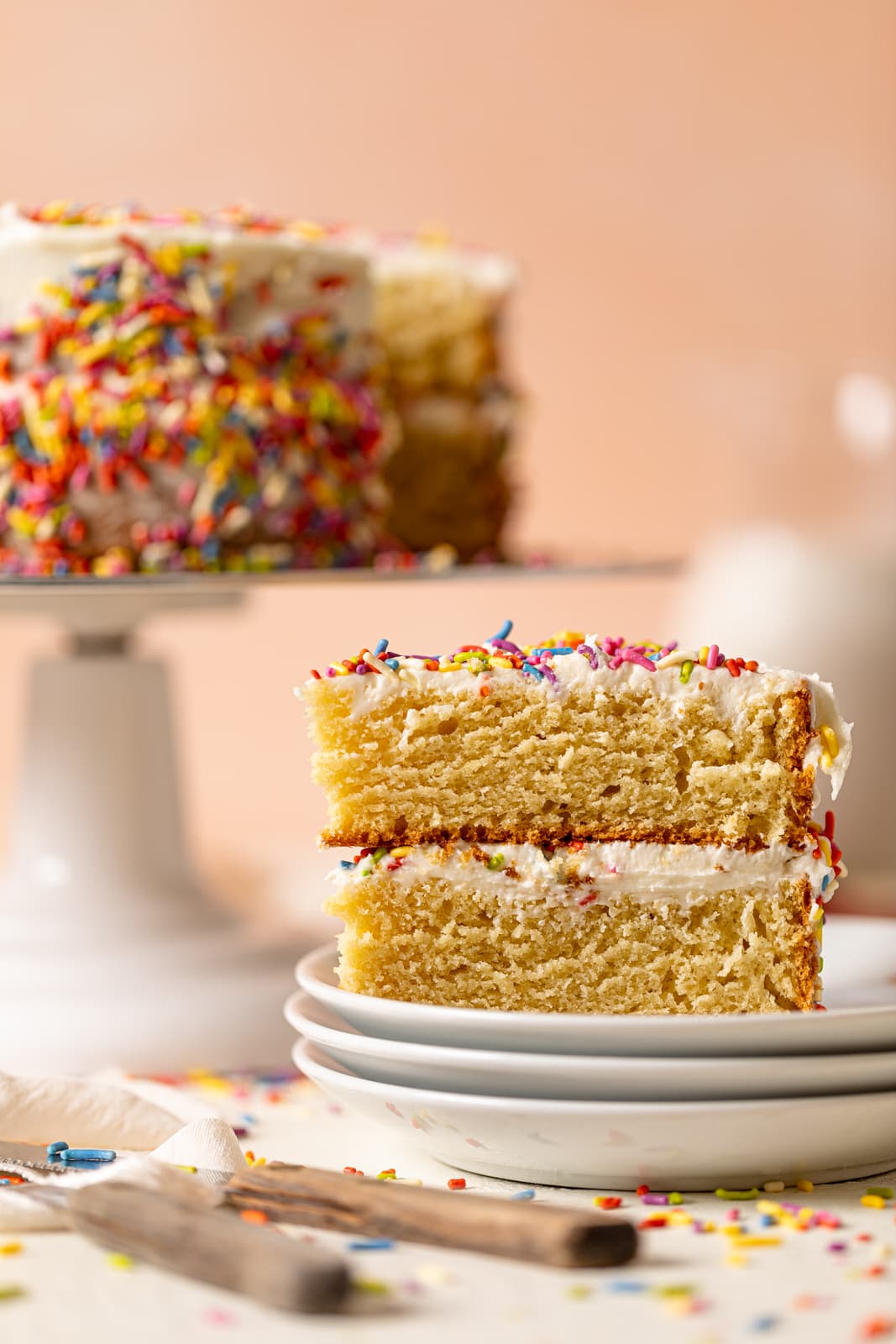 Slice of Vanilla Yogurt Cake with Sprinkles on three small stacked plates