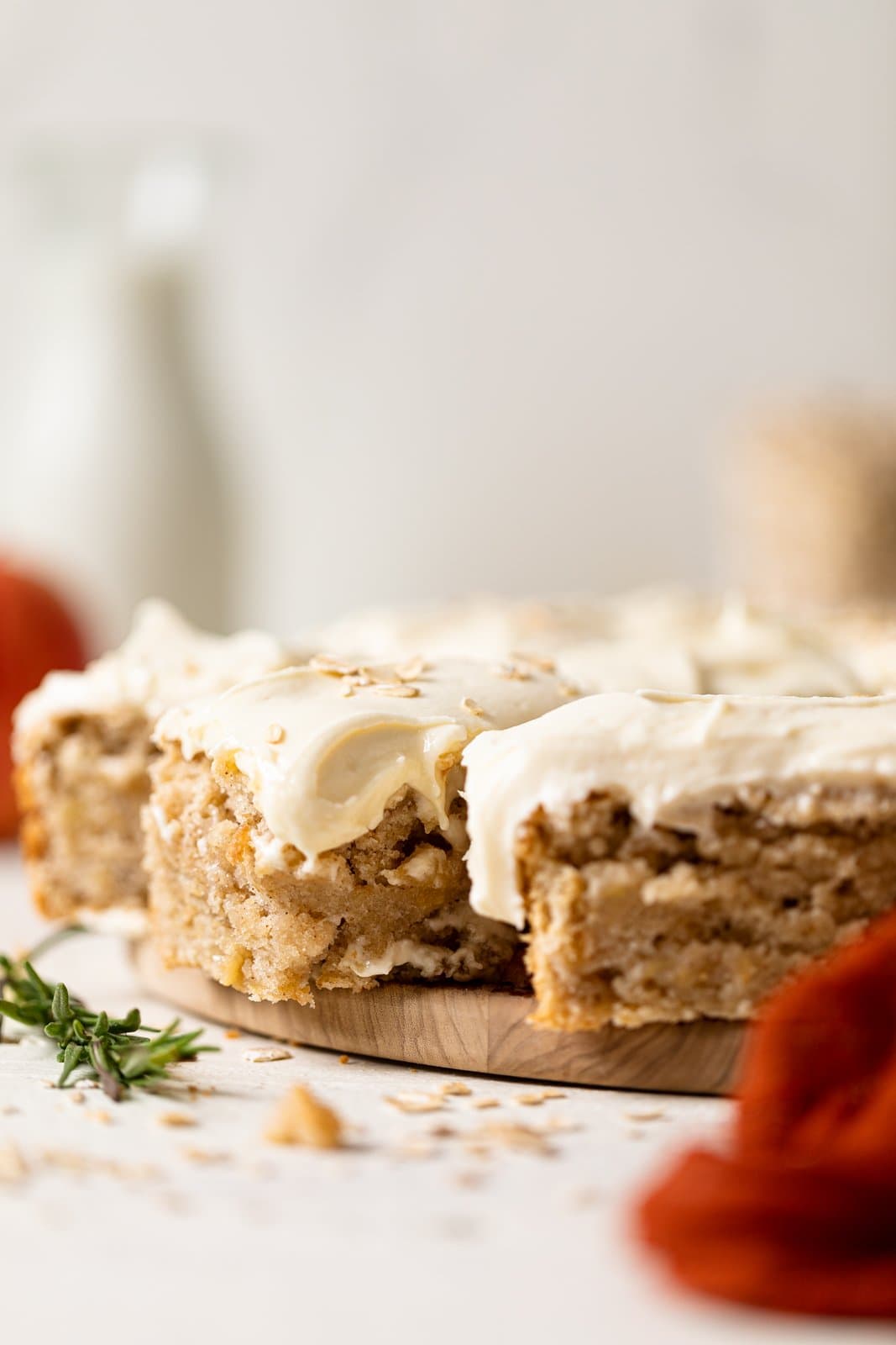 Slices of Vegan Apple Oatmeal Sheet Cake on a wooden serving platter