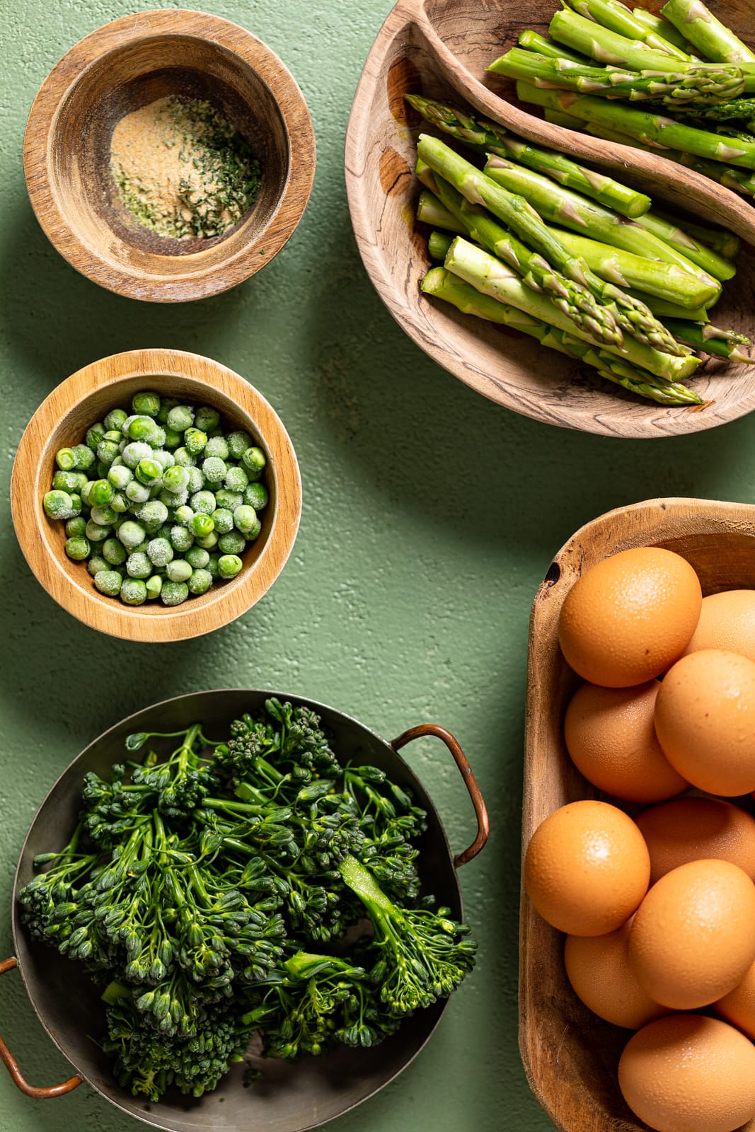 Ingredients for Spring Vegetable Frittata including eggs, asparagus, peas, and seasonings