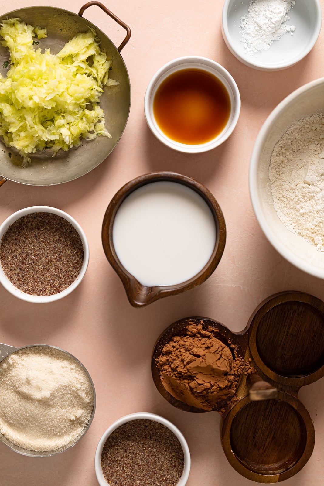 Ingredients for Vegan Zucchini Brownies including cocoa powder, flaxseed meal, and vanilla extract